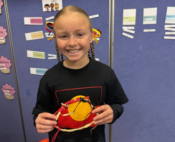Image of an aboriginal student showing her hand made bracelet.