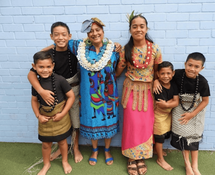 Photo of a teacher and five students in their traditional costumes for Harmony Day