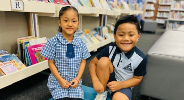 Two students sitting in the library. Ready to learn.